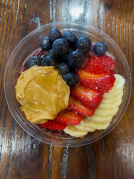 The fresh fruit acai bowl topped with peanut butter and fresh fruit at Kwench Juice Cafe in Destin, Florida.