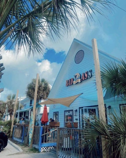 The beachy white aesthetic of the exterior of Bad Ass Coffee shop in Destin, Florida near 30A.