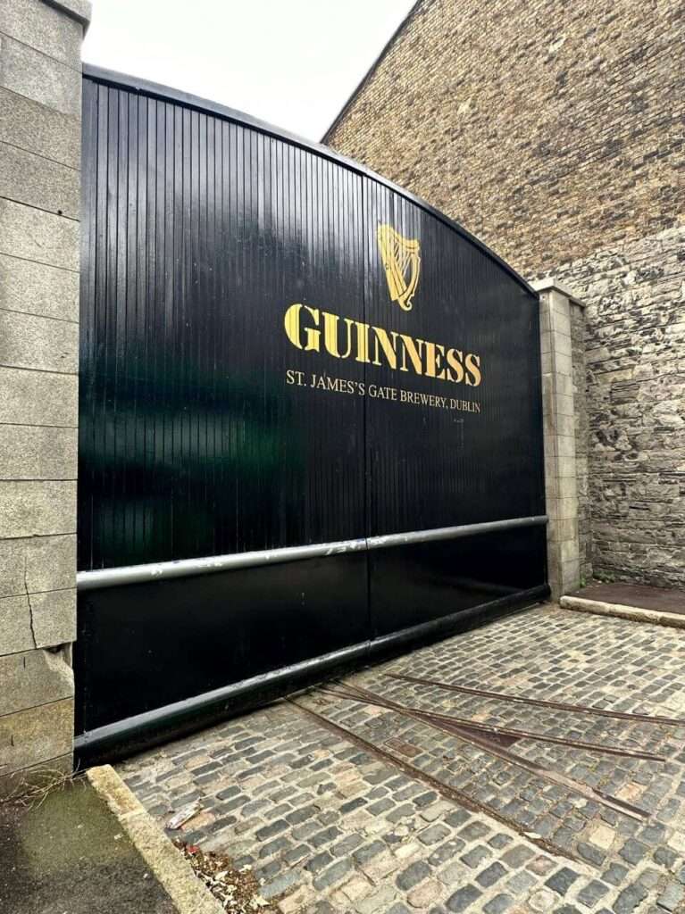 The black wooden gate outside of Guinness Storehouse in Dublin which is one of the popular things to do in Dublin for couples.