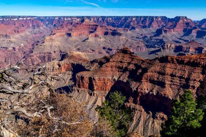 A stunning viewpoint looking into the bottom of the Grand Canyon overlooking towering peaks and sandy colors at Grand Canyon National Park in Arizona.