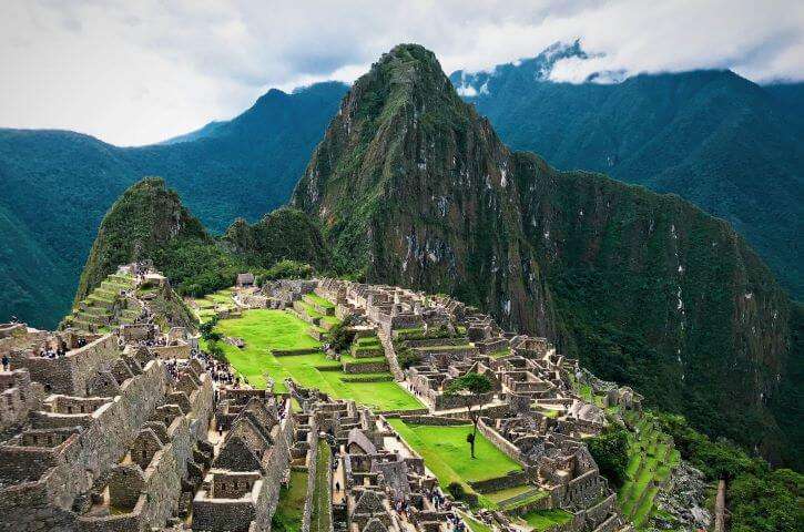 The large stone wall architecture of the ancient ruins of Machu Picchu located in the Andes Mountains as a popular item of 100 things to do before you die.