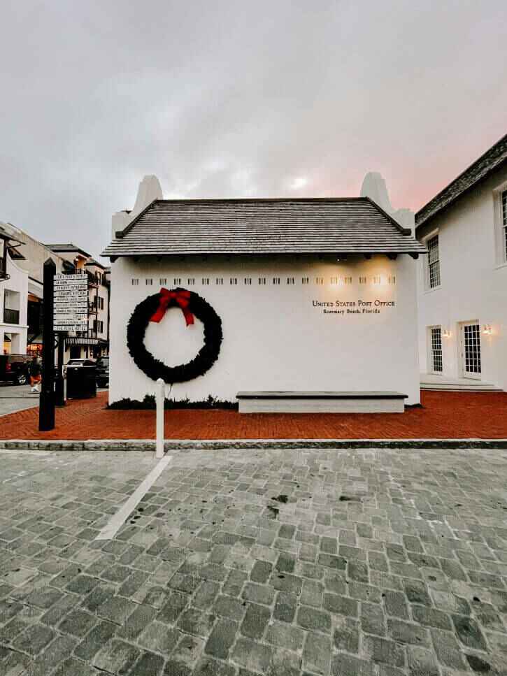 The beach town of Rosemary Beach featured is its white clay United States Post Office adorned with a large green wreath and red ribbon bow for Christmas.
