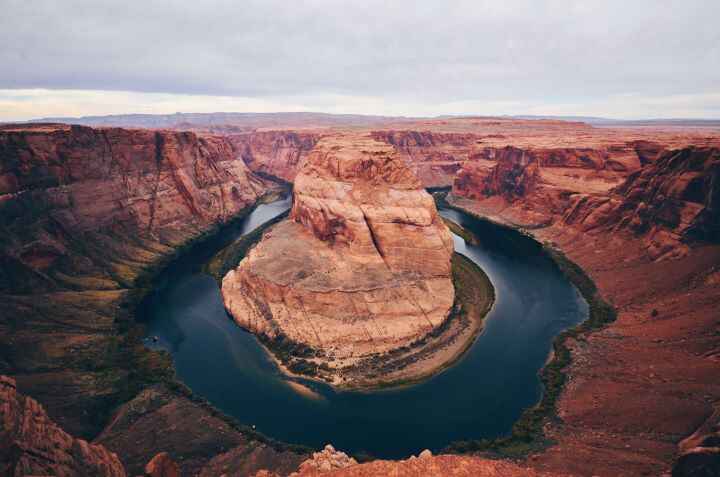 The view of Horseshoe Bend which is a popular stop on the way from Antelope Canyon to Zion National Park where from its viewpoint you see a bend around the canyon that resembles a horseshoe overlooking the Colorado River.