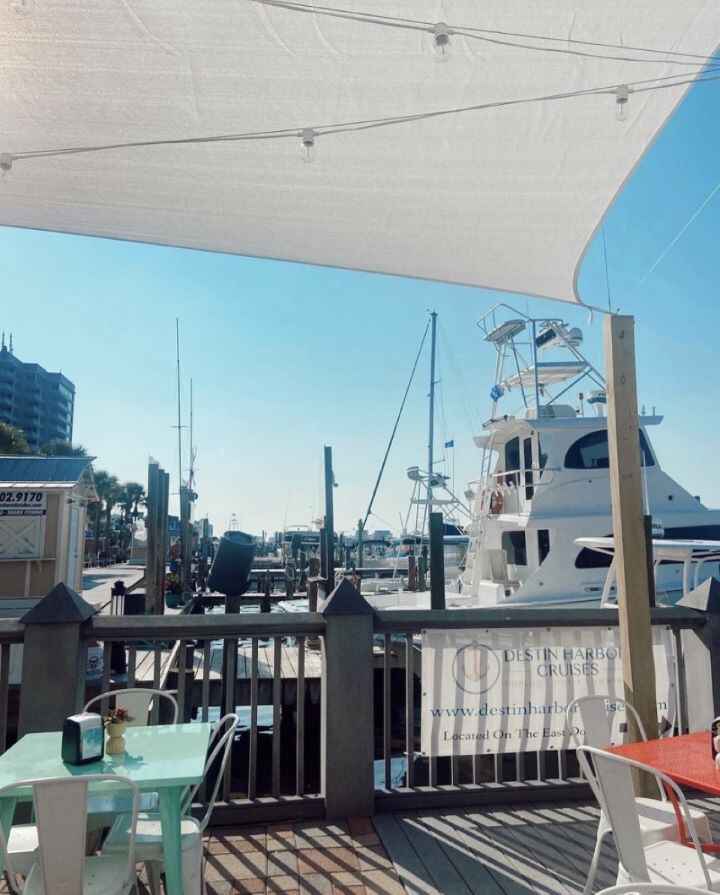 The boats docked at the Destin Harbor boardwalk from the view of the seating at Beignets & Brew.