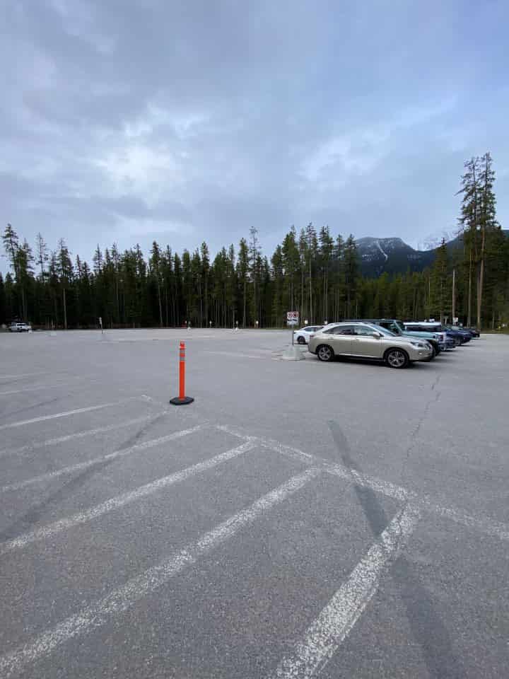 The empty parking lot at Johnston Canyon with a lot of open spaces on a weekday in late May in the morning.