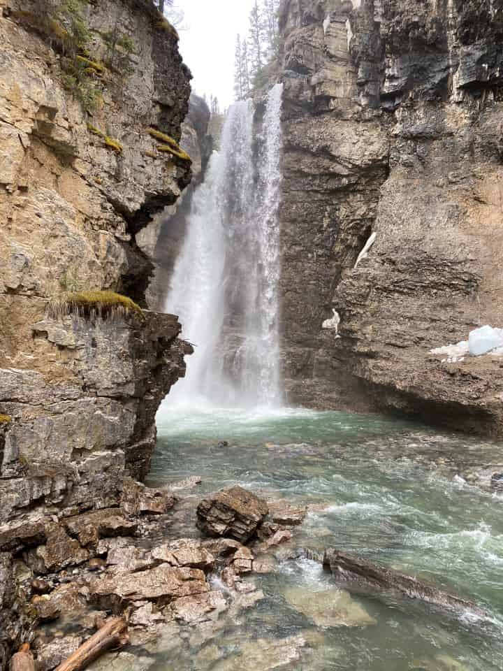 The view of the powerful Upper Falls surrounded by the canyon walls at Johnston Canyon.