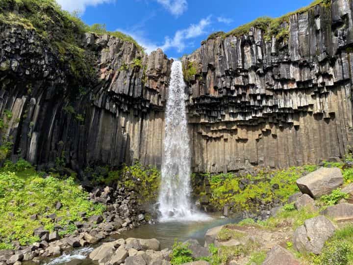 The stunning basalt column backdrop behind the tall and powerful Svartifoss waterfall in Iceland.