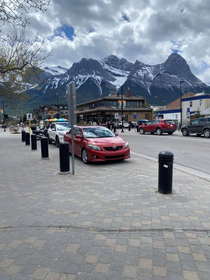 The view of the snow covered mountain peaks surrounding downtown Canmore which is a 25 minute drive from Banff.