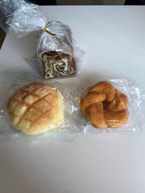 The crispy melon pan, sweet cinnamon donut, and fresh black bean bread sold at Melon Pan, Donut, and Black Bean Bread from Boulangerie Friandise Karasuma bakery in Kyoto.