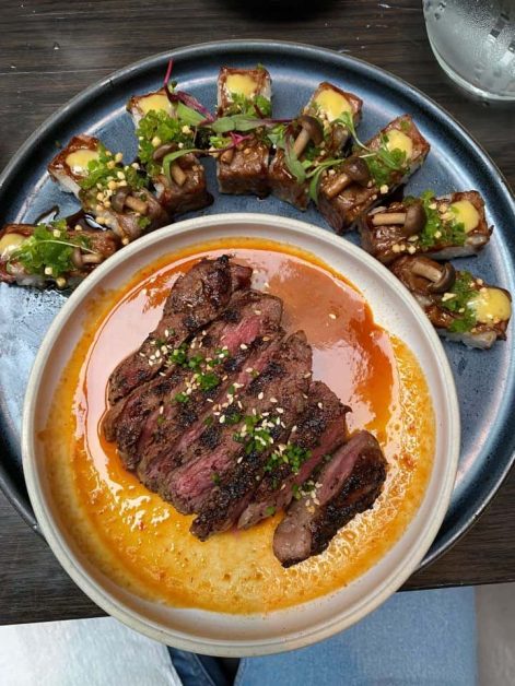 The spicy sauce covering the sirloin and sushi pieces served at Earl's Kitchen + Bar restaurant in Toronto which is a very popular spot for happy hour.