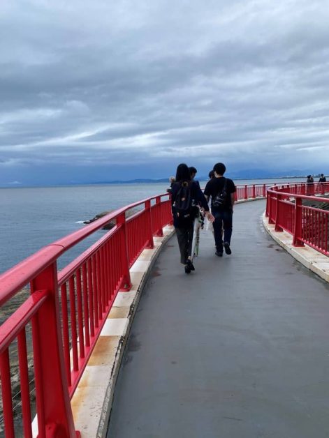 The bright red Enoshima Benten Bridge you can walk across while viewing the ocean and surrounding nature on Enoshima Island which is a quick train ride from Kamakura.