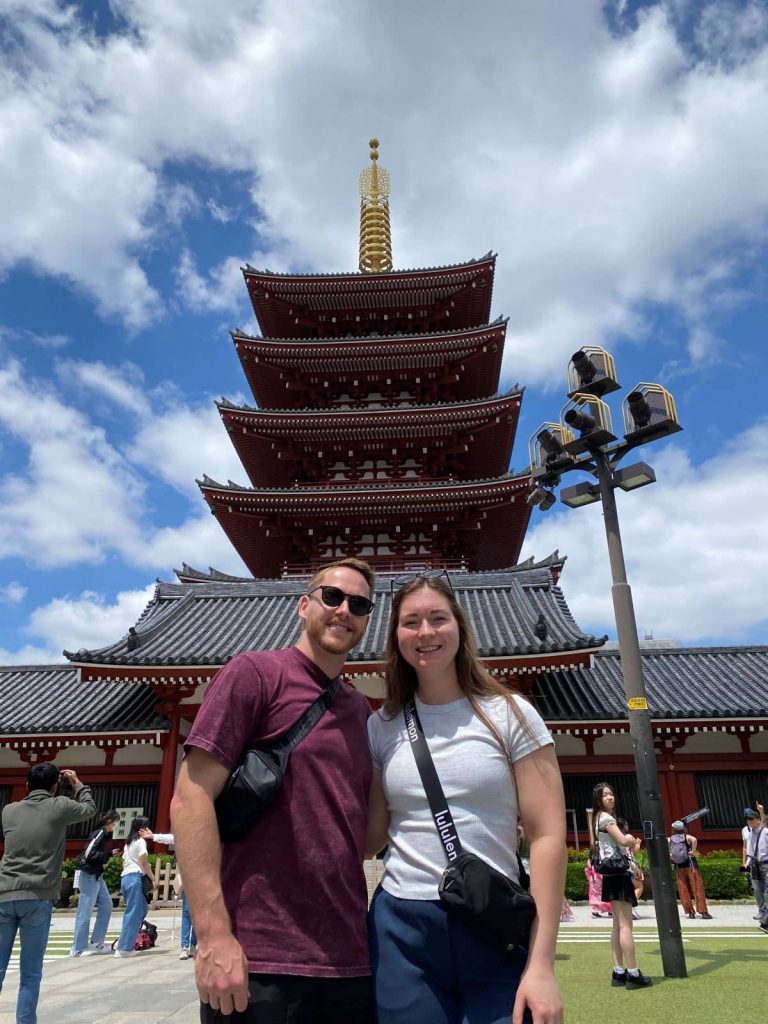 My husband and I in front of the five story pagoda near Sensō-ji Temple in Asakusa, Tokyo which is a free thing to do to lower your Japan trip cost.