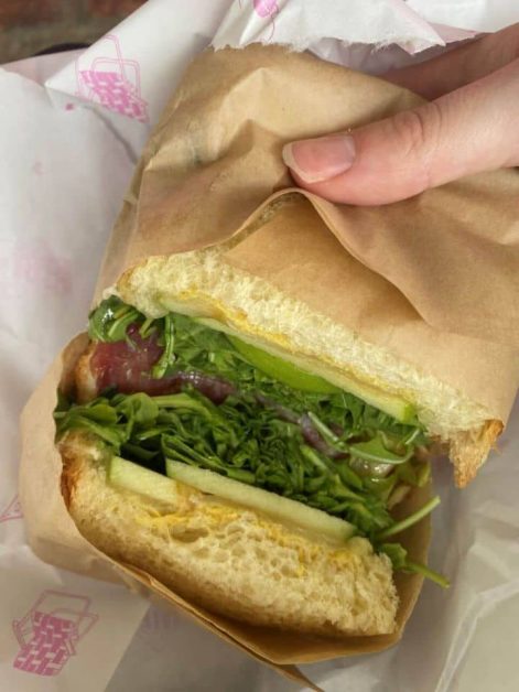 My delicious lunch sandwich from Call Your Mother Bagel deli in Georgetown featuring sourdough bread, lettuce, apples, and turkey.