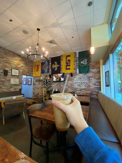 The delicious iced buzzin beehive latte sold at Bayou Bakery in Arlington, VA with its New-Orleans inspired decorated interior.