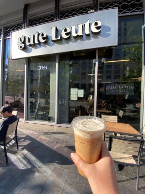Me holding my iced pink salted caramel cream latte outside of Gute Leute coffee shop in Arlington VA.