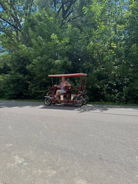 My dad driving our quadricycle we rented from Toronto Island Bicycle Rental to bike around Toronto Islands.