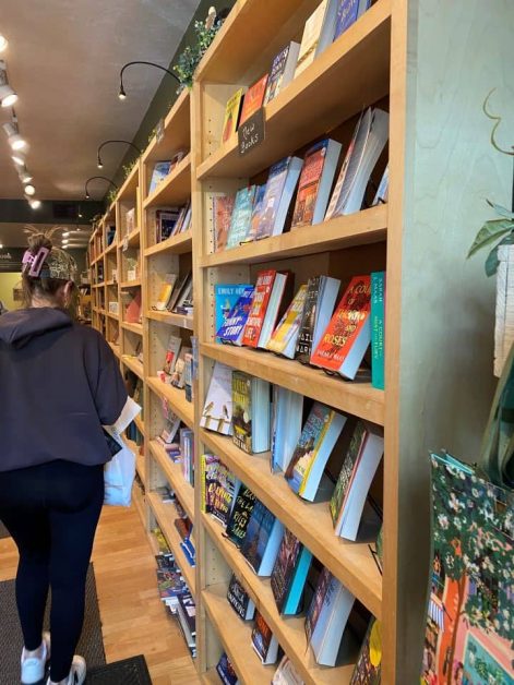 The books lining the wooden shelves inside of the Book Nook store in downtown Saugatuck that sells new and used books.