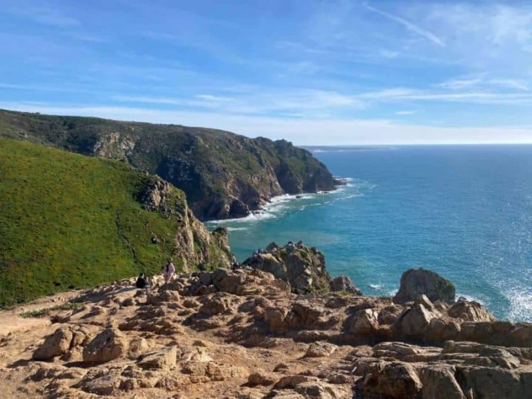 A breathtaking view from a cliff near Cabo da Roca lighthouse, showcasing the vast ocean and rugged coastline which is the highlight of the Cascais and Cabo da Roca day trip from Lisbon.