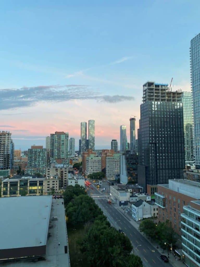 The beautiful pink and blue sunset setting behind the Toronto skyline that I witnessed from the rooftop patio of the TOOR hotel in Toronto.