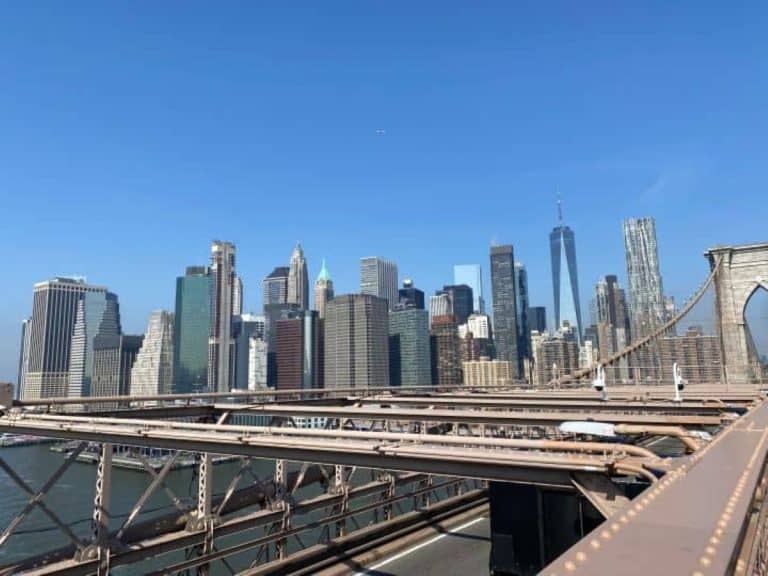 The view of the Manhattan skyline you can see while walking over the Brooklyn Bridge in New York City.