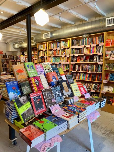 A beautifully displayed table of books at the Books are Magic bookstore in Brooklyn NYC.