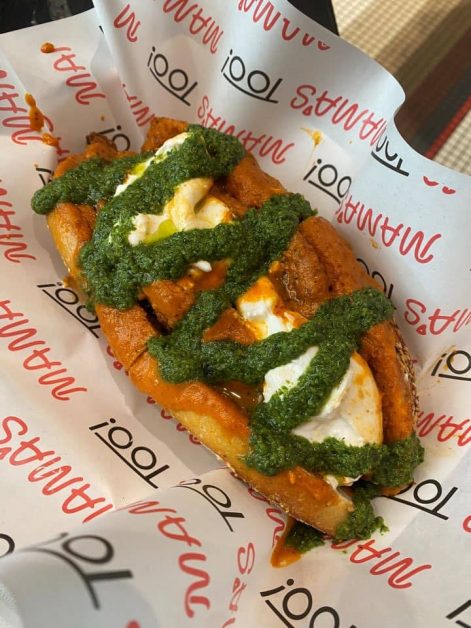 The chicken alla vodka sandwich from Mama's TOO! pizza shop in New York City topped with green pesto, burrata cheese, marinara, and chicken.