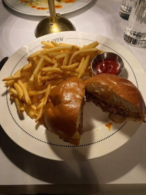 A delicious double smash cheeseburger served with skinny fries and a side of ketchup at Hoexter's restaurant in New York City.