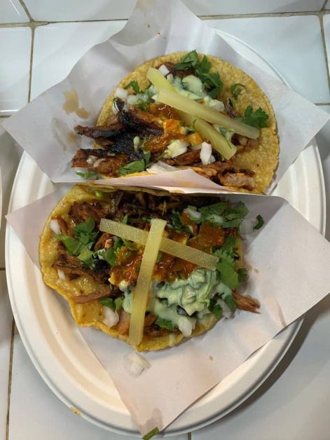 The spicy pork tacos topped with pineapple, guacamole, onions, and cilantro from Los Tacos No 1 in New York City.