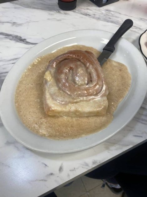 Large glazed cinnamon roll covered in cream cheese frosting from Manny's Snack Shack in Lake Geneva, Wisconsin.