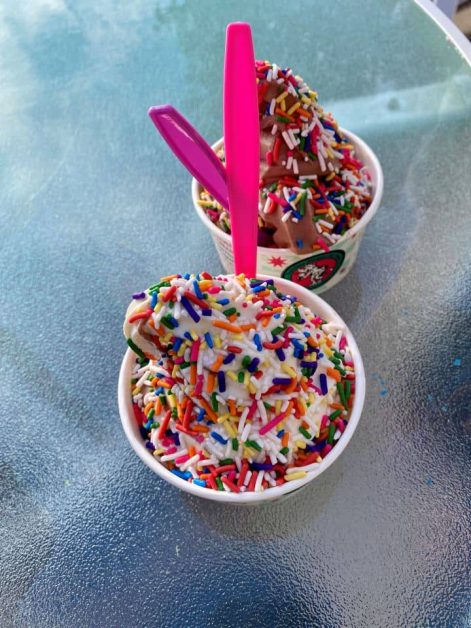 Two cups of rainbow sprinkle soft serve ice cream from Scoops in Lake Geneva, Wisconsin.
